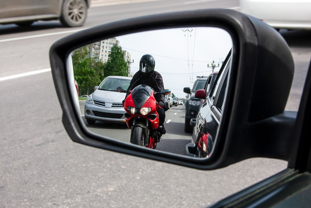 Red Motorcycle In The Rear-View Mirror