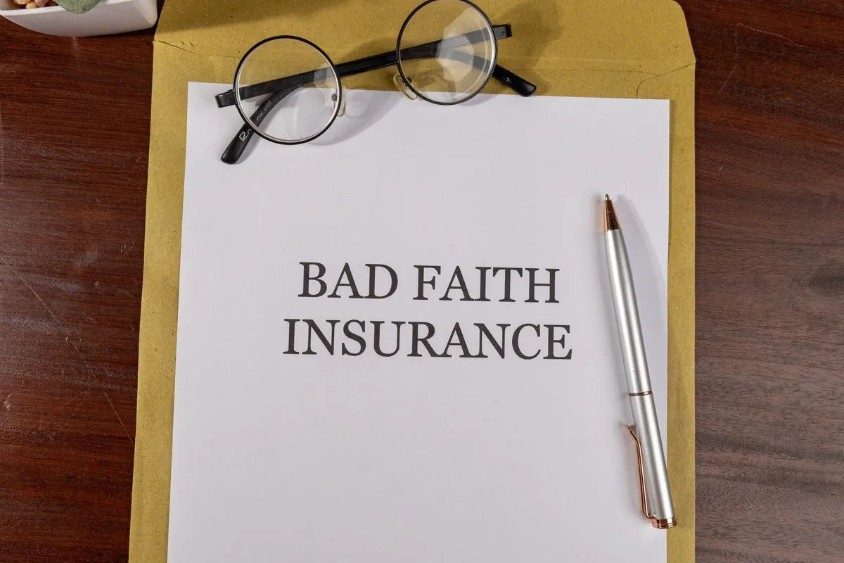 Legal Paper Titled ‘Bad Faith Insurance’ Placed on Envelope with Pen – Insurance Law Concept