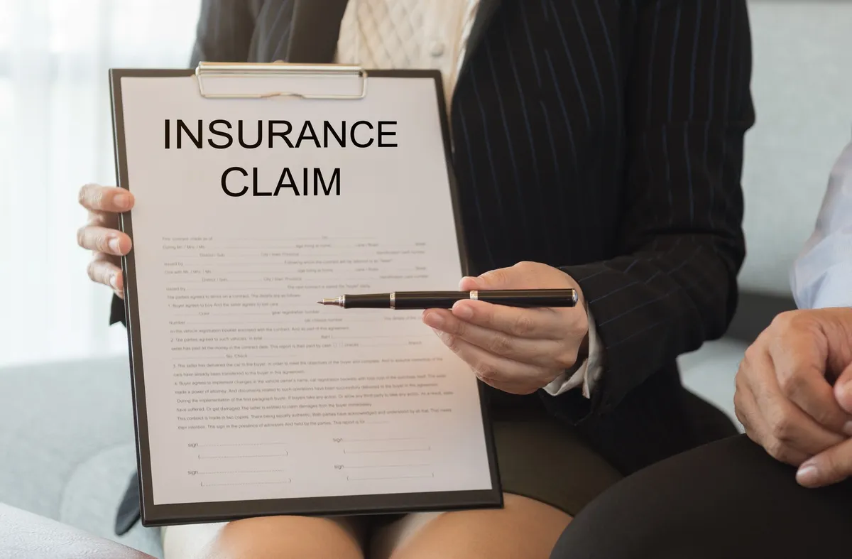 Insurance agent sends pen and insurance claim form for signing contract. insurance claim concept.