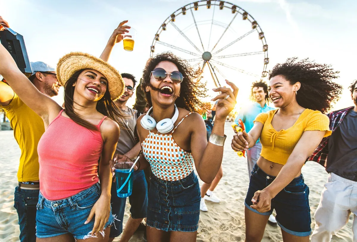 Multiracial group of friends having fun dancing on the beach - Happy people enjoying music festival on weekend vacation