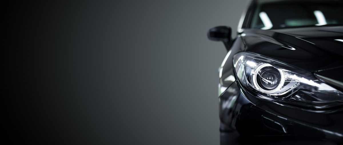 Black modern car on black background.