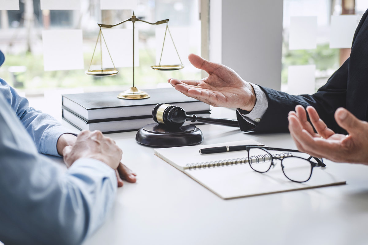 Consultation and conference of Male lawyers and professional businesswoman working and discussion having at law firm in office. Concepts of law, Judge gavel with scales of justice.