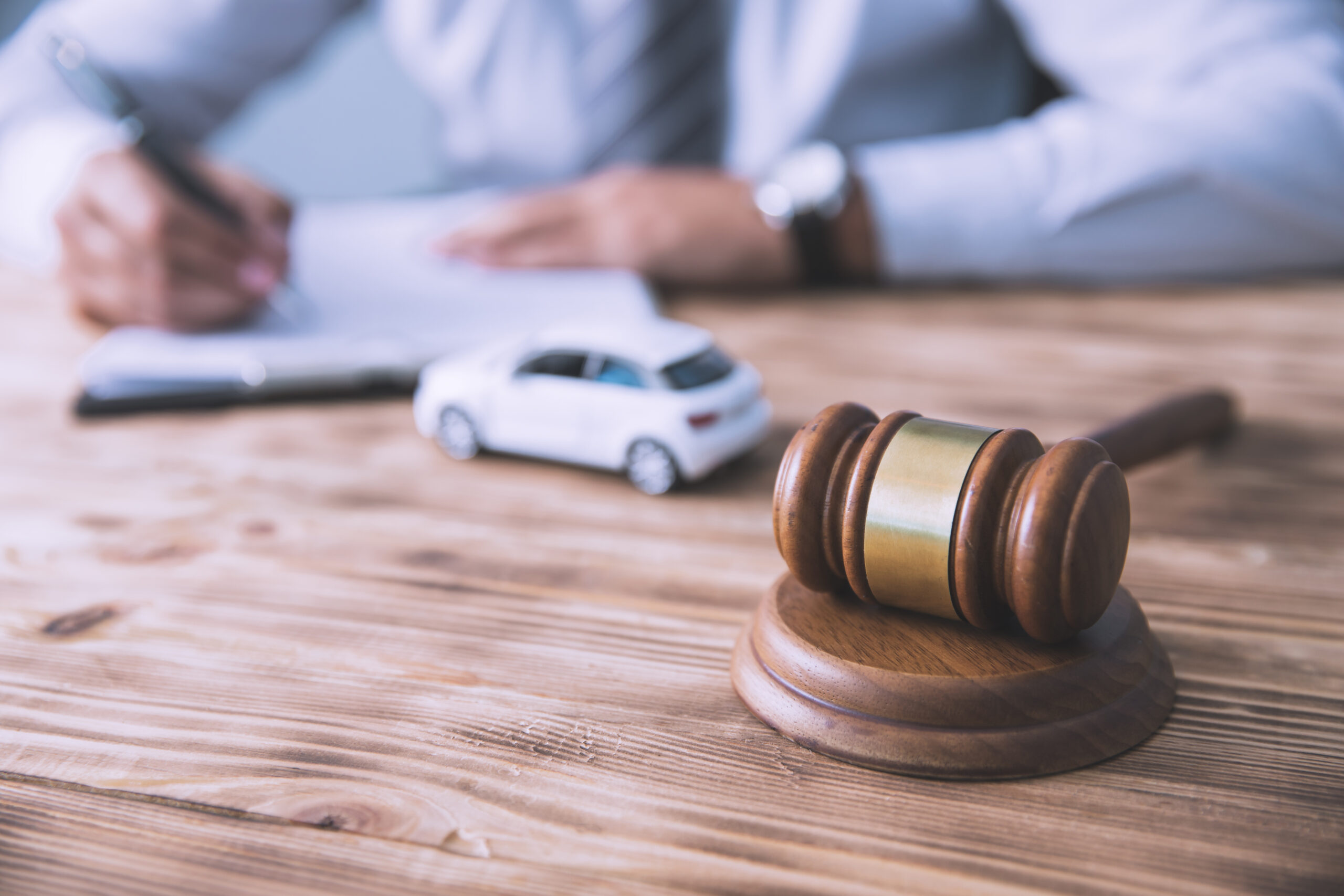 man hand judge with car model and document