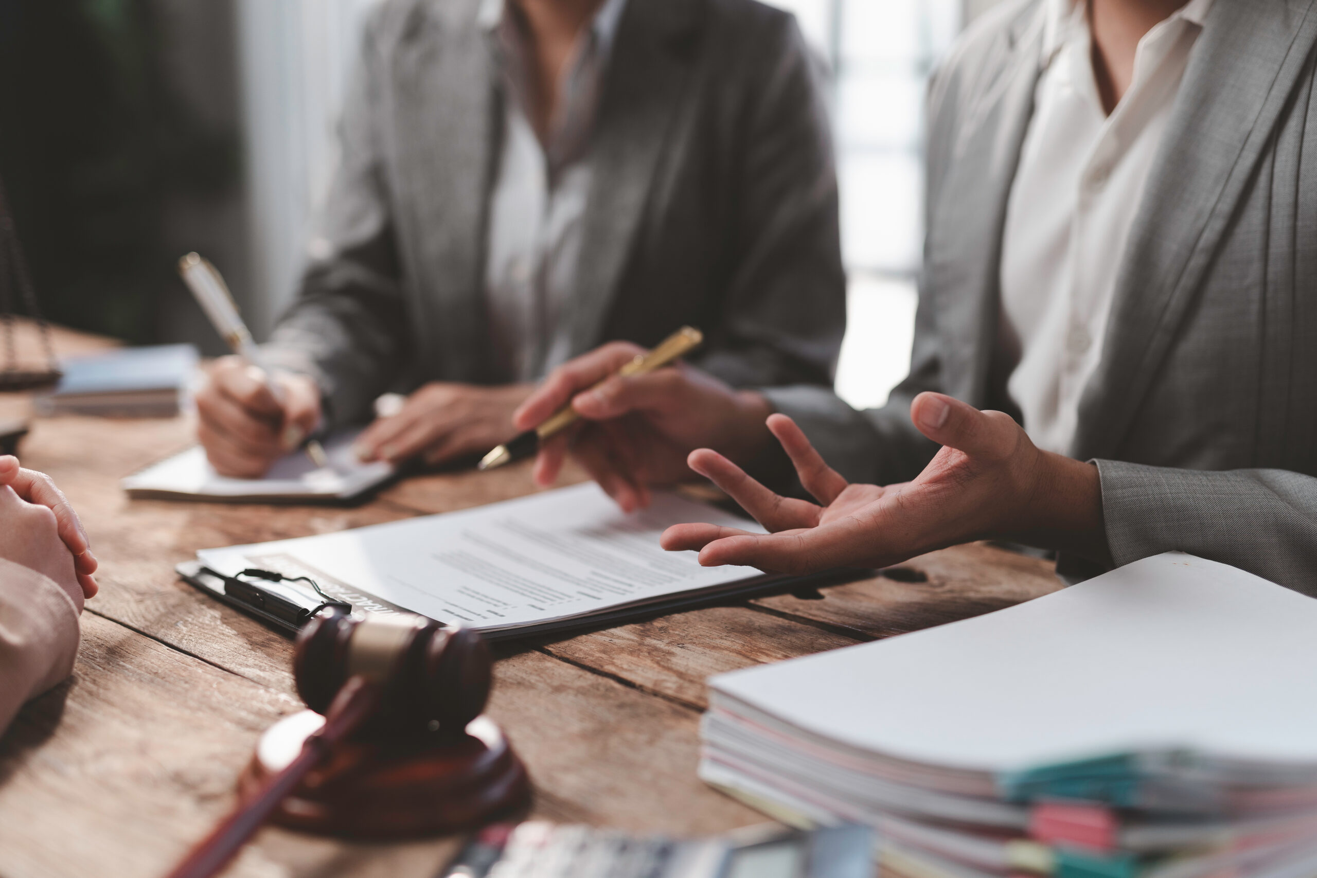 Lawyers discussing contract details during a meeting in a law firm office