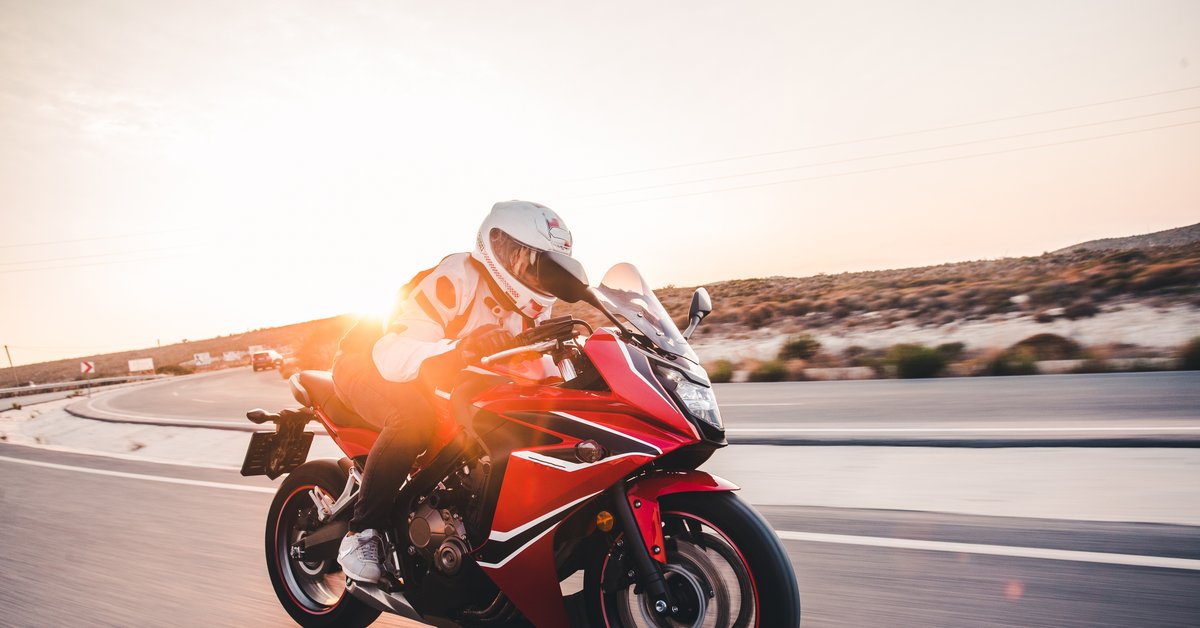 Motorcyclist riding on a Houston-area highway at sunset, representing a motorcycle accident case in Texas