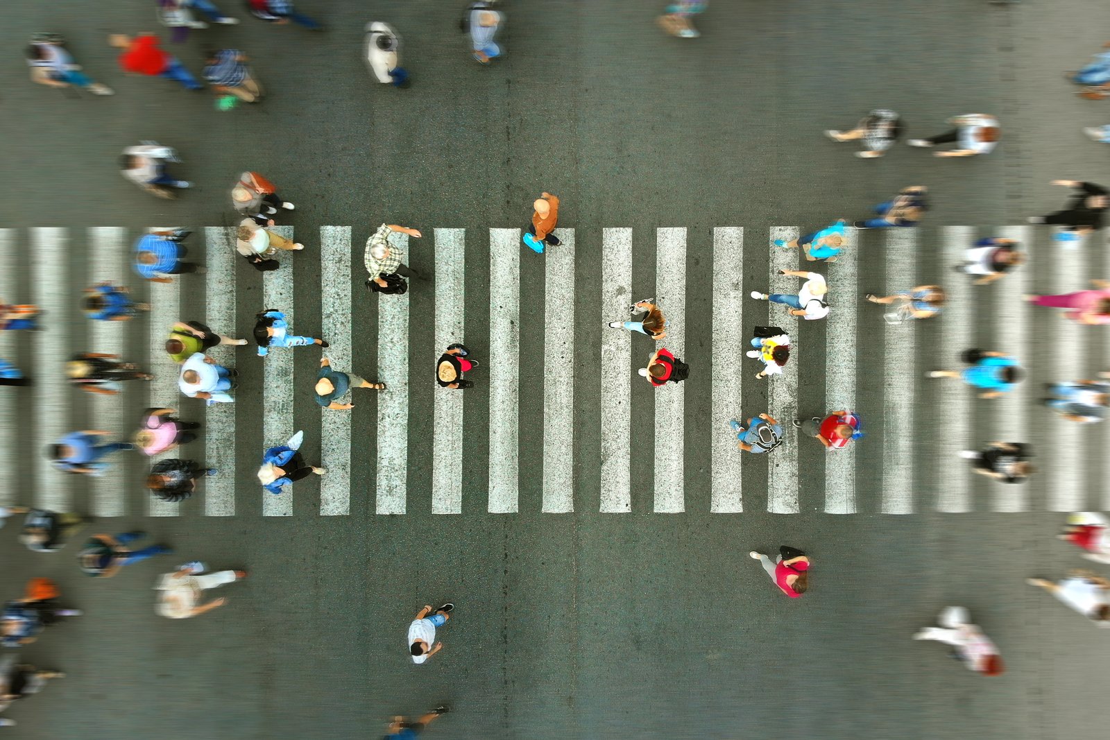 Pedestrians crossing a busy city street in Hialeah